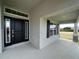 Contemporary black front door with sidelights and transom window for added natural light at 25156 Rosamond Ct, Punta Gorda, FL 33983