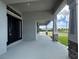 Covered front porch with stone columns providing ample space to relax and enjoy the outdoors at 25156 Rosamond Ct, Punta Gorda, FL 33983