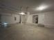 Spacious two car garage with concrete floor and ladder access to overhead storage at 25156 Rosamond Ct, Punta Gorda, FL 33983