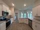 Modern kitchen with stainless steel appliances, granite countertops, and white cabinets at 25156 Rosamond Ct, Punta Gorda, FL 33983