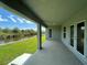 Relaxing covered patio overlooking green grass and peaceful water view at 25156 Rosamond Ct, Punta Gorda, FL 33983