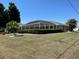 Spacious backyard view featuring an inviting screened-in lanai for outdoor enjoyment at 25263 Padre Ln, Punta Gorda, FL 33983