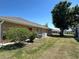 Lush backyard featuring well-maintained lawn, mature trees, and a peaceful setting at 25263 Padre Ln, Punta Gorda, FL 33983