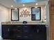 Bright bathroom showcases dual vanities with granite countertops and a beautifully tiled shower at 25263 Padre Ln, Punta Gorda, FL 33983