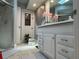 Bathroom featuring a shower, a door to the outside and a vanity with plenty of storage at 25263 Padre Ln, Punta Gorda, FL 33983