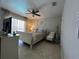 Bright bedroom featuring neutral decor, ceiling fan, and a comfortable seating area at 25263 Padre Ln, Punta Gorda, FL 33983