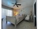 Bright bedroom featuring neutral decor, ceiling fan, and a comfortable seating area at 25263 Padre Ln, Punta Gorda, FL 33983