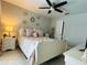 Bedroom featuring neutral decor, ceiling fan, and a bedside table with a lamp at 25263 Padre Ln, Punta Gorda, FL 33983