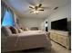 Bedroom featuring a ceiling fan, light colored walls, and neutral colored decor at 25263 Padre Ln, Punta Gorda, FL 33983