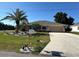 Charming home with a well-maintained front yard, attractive landscaping, and a welcoming entrance at 25263 Padre Ln, Punta Gorda, FL 33983