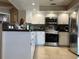Bright kitchen features stainless steel appliances, tile backsplash, and ample counter space at 25263 Padre Ln, Punta Gorda, FL 33983