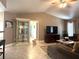 Bright living room showcases a display cabinet, TV, neutral walls, and decorative accents at 25263 Padre Ln, Punta Gorda, FL 33983