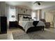 Bright main bedroom featuring a bed, modern decor, and access to a sliding glass door at 25263 Padre Ln, Punta Gorda, FL 33983