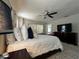 Cozy main bedroom with ceiling fan, plush bedding, and sliding glass doors at 25263 Padre Ln, Punta Gorda, FL 33983