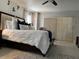 Bedroom with plush bed, a ceiling fan, and sliding glass doors for natural light at 25263 Padre Ln, Punta Gorda, FL 33983