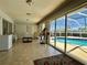 Enclosed lanai with tiled floors, ceiling fan, bright light and access to pool at 25263 Padre Ln, Punta Gorda, FL 33983