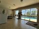 Enclosed lanai with tiled floors, ceiling fan, bright light and access to pool at 25263 Padre Ln, Punta Gorda, FL 33983