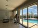 Enclosed lanai with tiled floors, ceiling fan, bright light and access to pool at 25263 Padre Ln, Punta Gorda, FL 33983