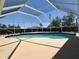 Screened-in pool with clear blue water, spacious deck, and a refreshing view at 25263 Padre Ln, Punta Gorda, FL 33983