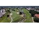 Aerial view of Deep Creek Golf Course with water and trees at 26209 Madras Ct, Punta Gorda, FL 33983