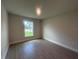 Cozy bedroom featuring hardwood floors and a bright window with a view at 26209 Madras Ct, Punta Gorda, FL 33983