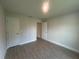A clean bedroom with tile floors, neutral walls, and ample closet space showcases minimalist design at 26209 Madras Ct, Punta Gorda, FL 33983