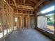 Interior framing of a new home construction with concrete block walls and wooden beams at 26209 Madras Ct, Punta Gorda, FL 33983