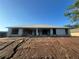 Exterior view of home with block construction and a large front yard under construction at 26209 Madras Ct, Punta Gorda, FL 33983