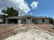 Charming single-story home featuring a light gray exterior, white trim and an attached garage at 26209 Madras Ct, Punta Gorda, FL 33983