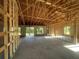 Unfinished interior showing exposed framing, windows, and concrete floors in a new home construction project at 26209 Madras Ct, Punta Gorda, FL 33983