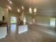Modern kitchen with granite countertops and stainless steel appliances, flowing into an open living area at 26209 Madras Ct, Punta Gorda, FL 33983