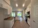 Bright kitchen features white cabinets, granite countertops, stainless appliances, and an island with a sink overlooking a yard at 26209 Madras Ct, Punta Gorda, FL 33983