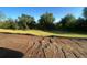 Raw land ready to be developed, with dirt and surrounding trees at 26209 Madras Ct, Punta Gorda, FL 33983