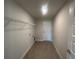 A clean laundry room features tile floors, a wire shelf, and hookups for a washer and dryer at 26209 Madras Ct, Punta Gorda, FL 33983