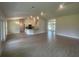 Open-concept living space with tile floors, bright lighting, and seamless flow to the kitchen at 26209 Madras Ct, Punta Gorda, FL 33983