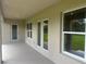 A covered back patio includes a door and windows with a backyard view, showcasing outdoor living space at 26209 Madras Ct, Punta Gorda, FL 33983