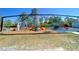 Outdoor playground with climbing wall, swings, slides, and covered seating area for community enjoyment at 26209 Madras Ct, Punta Gorda, FL 33983