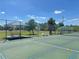 Outdoor recreational area with picnic tables, sunshades and tennis court at 26209 Madras Ct, Punta Gorda, FL 33983