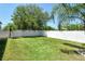 Large, green backyard enclosed by a white vinyl fence, offering privacy and space at 27854 Arrowhead Cir, Punta Gorda, FL 33982