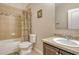 The charming bathroom features tiled walls and a shower with a shower curtain, paired with a vanity for a functional space at 27854 Arrowhead Cir, Punta Gorda, FL 33982