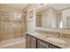 Bathroom featuring double sinks, granite counters, and a glass-enclosed shower at 27854 Arrowhead Cir, Punta Gorda, FL 33982