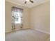 This cozy bedroom features neutral walls, carpeted floors, and a ceiling fan, offering a comfortable and inviting space at 27854 Arrowhead Cir, Punta Gorda, FL 33982