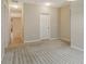 Spacious carpeted bedroom featuring an entranceway, door, and neutral color at 27854 Arrowhead Cir, Punta Gorda, FL 33982