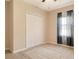 This bedroom features carpeted floors, a ceiling fan, a window with curtains and a closet with folding doors at 27854 Arrowhead Cir, Punta Gorda, FL 33982