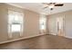 Bright bedroom featuring wood flooring, a ceiling fan, and ample natural light at 27854 Arrowhead Cir, Punta Gorda, FL 33982