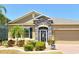 Charming home with stone accents, decorative front door, and well-maintained landscaping at 27854 Arrowhead Cir, Punta Gorda, FL 33982