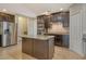 Kitchen featuring an island with stone countertops, stainless steel appliances, and dark wood cabinets at 27854 Arrowhead Cir, Punta Gorda, FL 33982