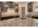 Granite counters accent this modern kitchen with stainless steel appliances and dark wood cabinetry at 27854 Arrowhead Cir, Punta Gorda, FL 33982