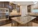 Kitchen showcasing an island with stone countertops and modern appliances at 27854 Arrowhead Cir, Punta Gorda, FL 33982