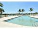 Enjoy the community pool surrounded by lounge chairs and featuring palm trees for a resort-like experience at 27854 Arrowhead Cir, Punta Gorda, FL 33982